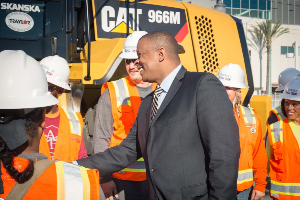 Secretary Anthony Foxx greeting workers who will build the project.